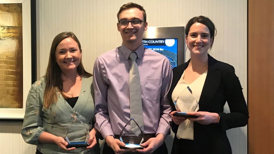 The 2019 consulting challenge team winners, Emily Raulston from Minnesota State University, Mankato, Colton Pogalz from St. Cloud State University, Michelle Mouton from University of Houston - Clear Lake, posing for a photo holding their awards