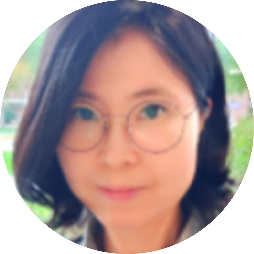 woman with round glasses smiling