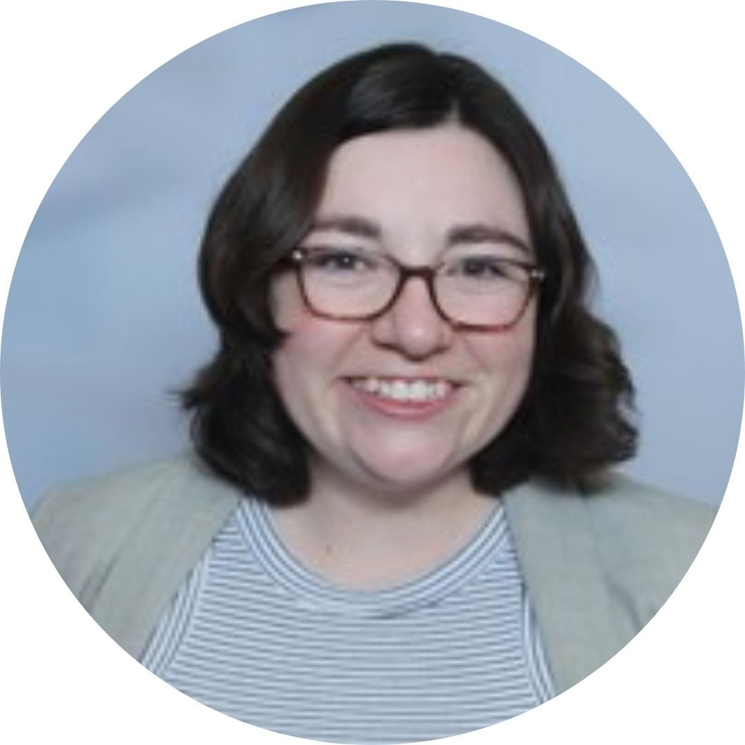 woman with glasses smiling, with blue background