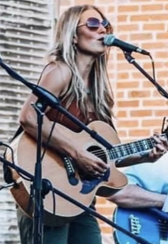 A closeup photo of Andrea Lyn during an outside concert