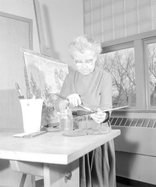 The artist and instructor Effie R. Conkling in the classroom painting