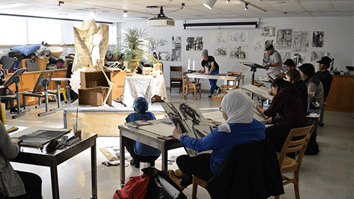 a group of people drawing in a room