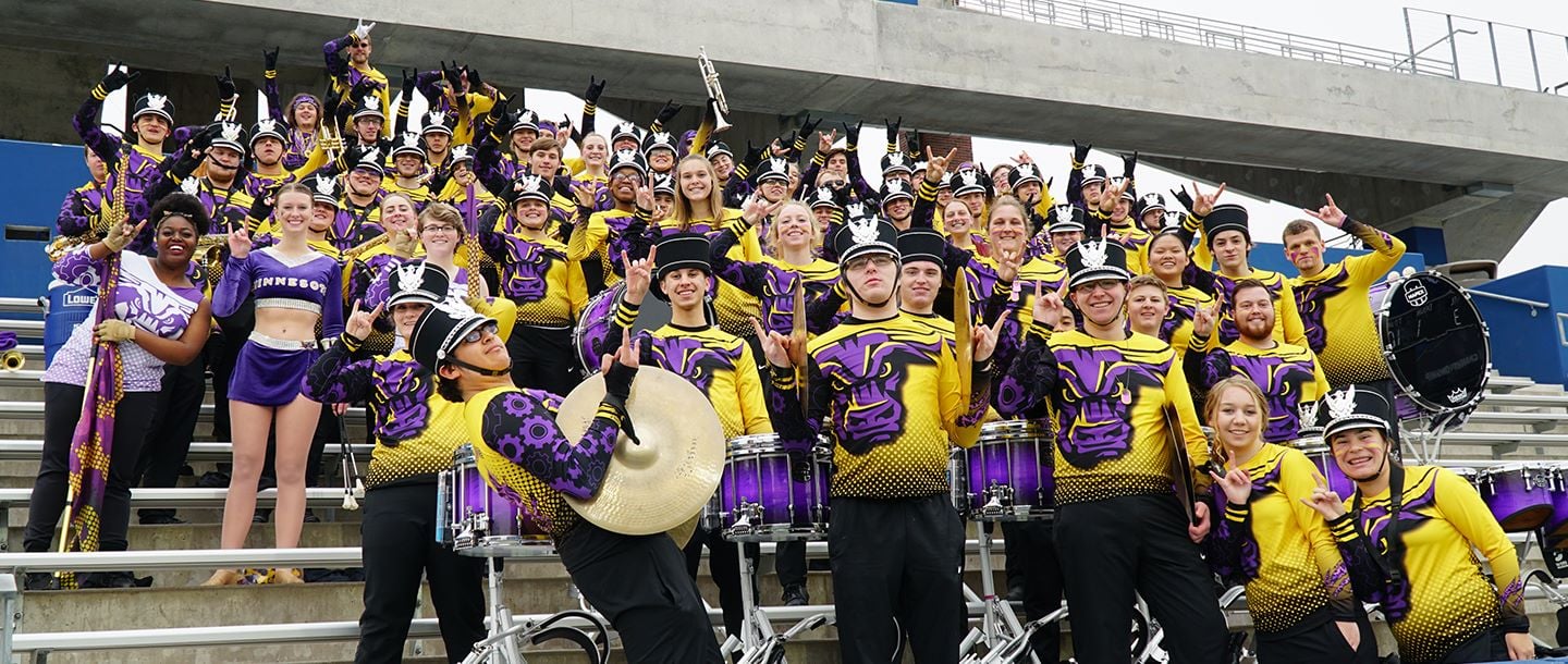 Maverick Machine marching band posing in the stands
