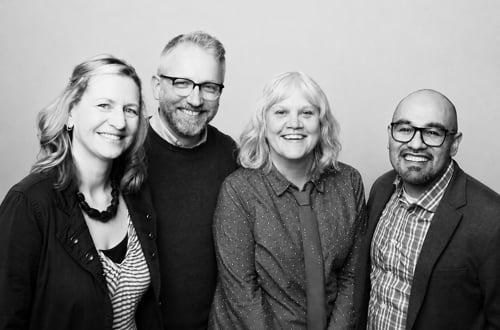 The Creative Writing faculty posing for a group photo with smiles