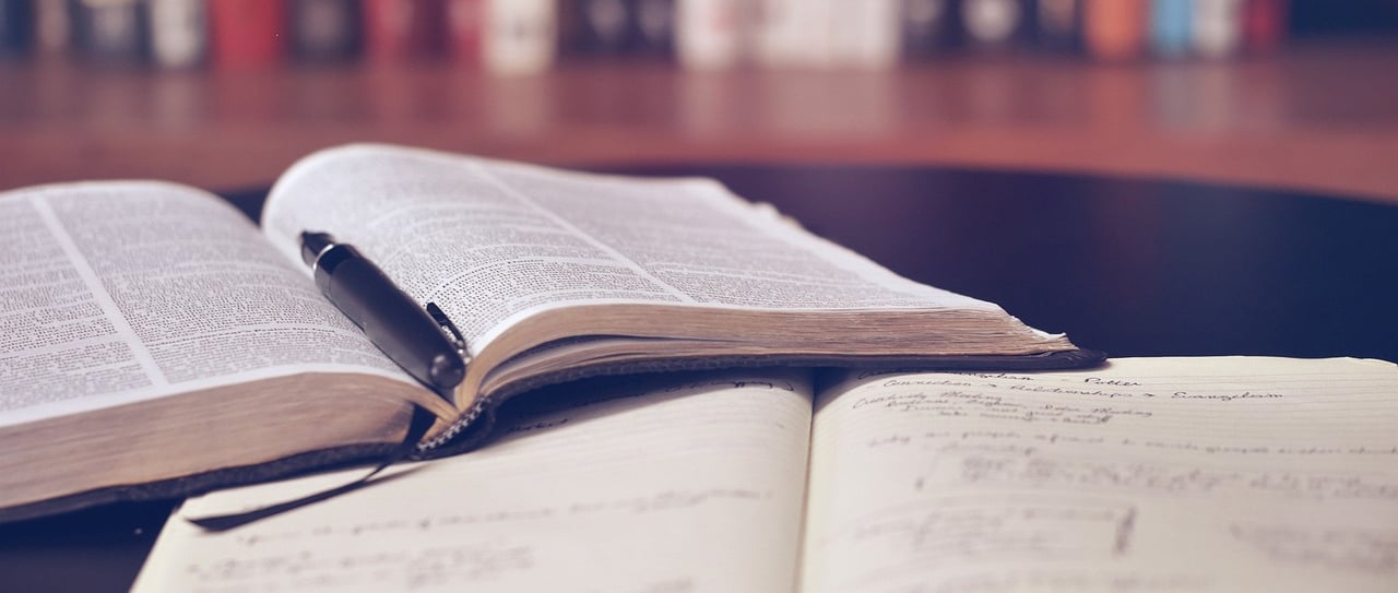 a book and pen on a table