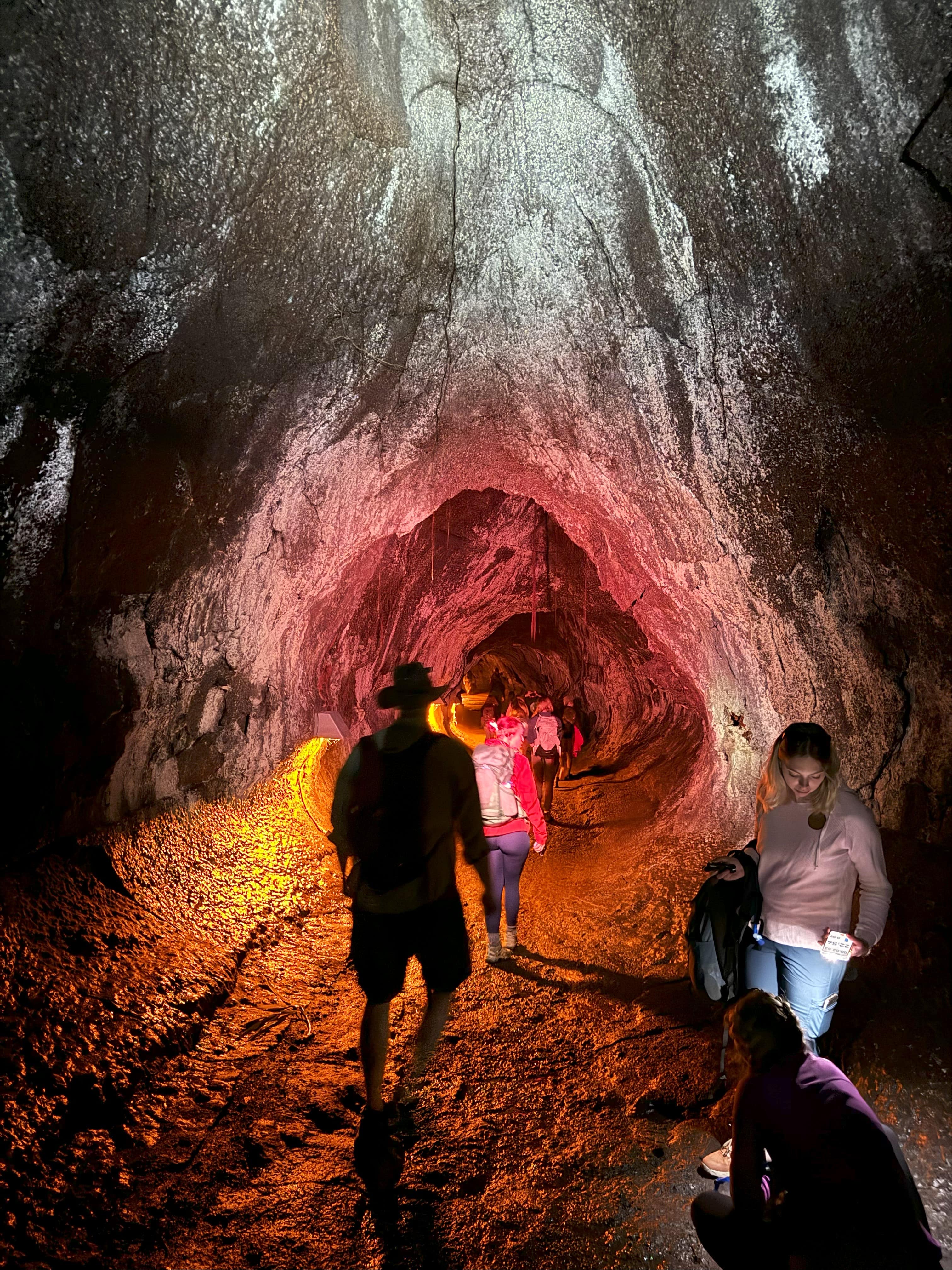 a group of people walking in a cave