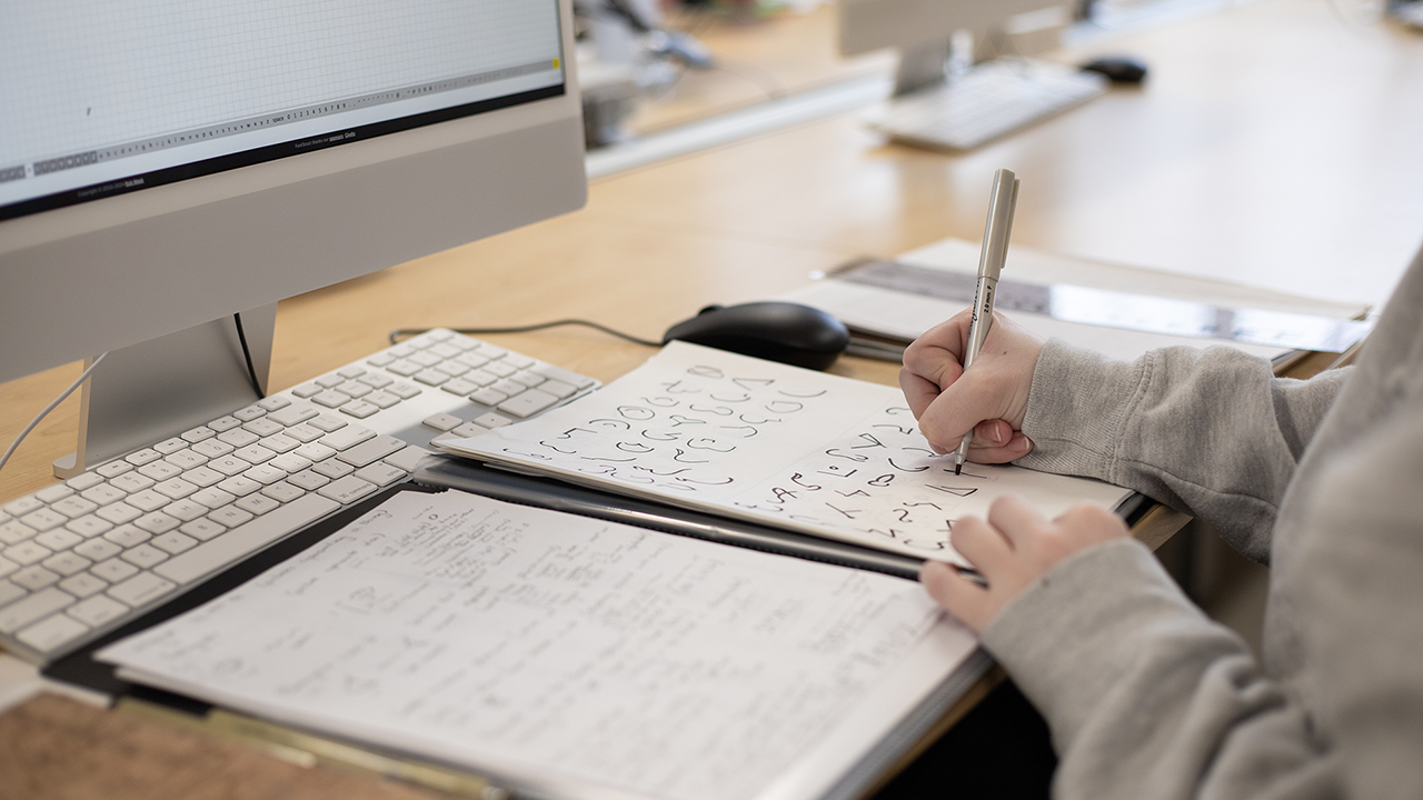 a person writing on a piece of paper