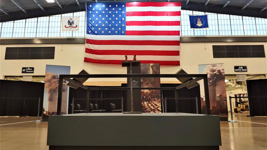 The Resolute: MN Stories of 9/11 and The War Traveling Exhibit in an auditorium displayed under the United States flag 