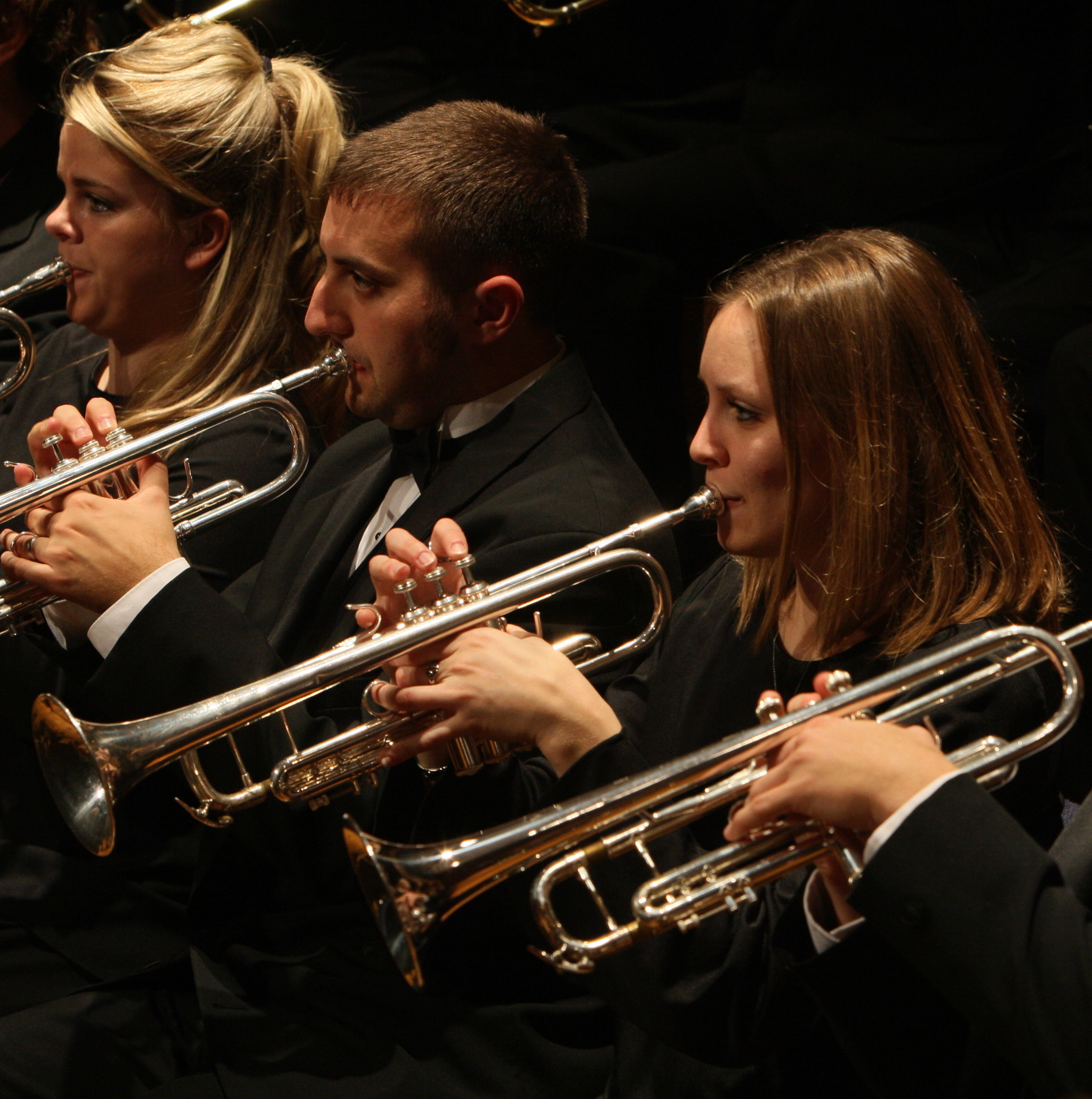 a group of people playing trumpets