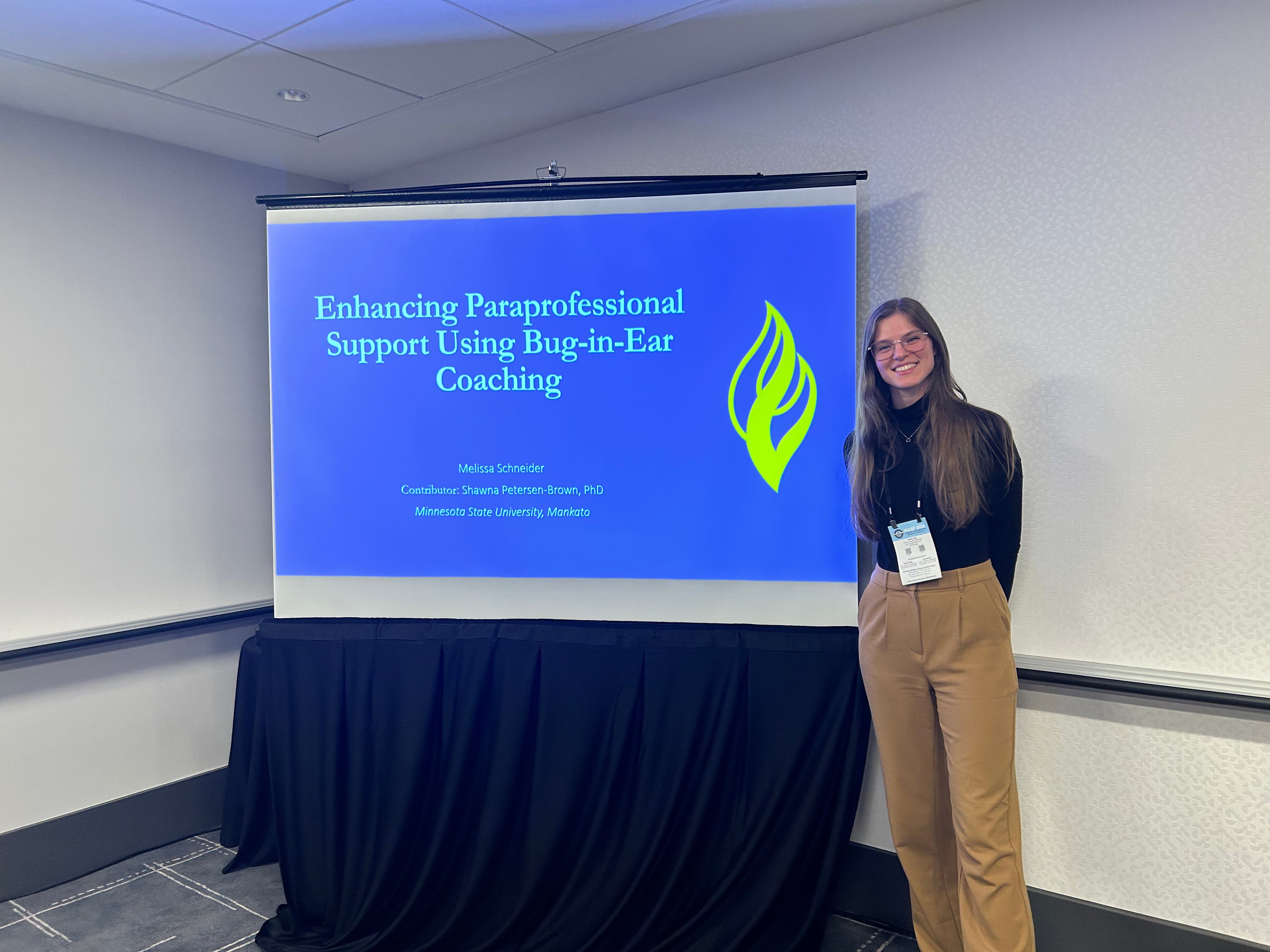 Melissa Scheider infront of her slide taking a picture