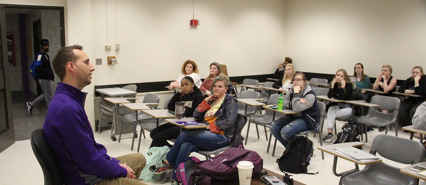 a group of people sitting in a classroom