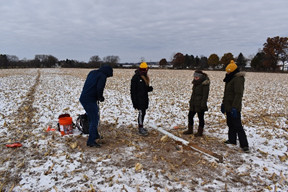 a group of people standing in a field