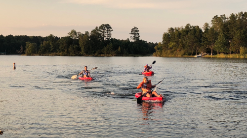 I-O psychology students kayaking on the lake at the fall conference