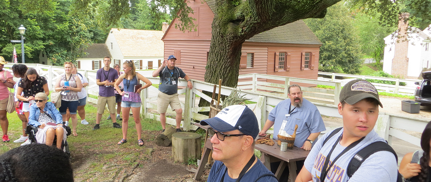 a group of people outside by a tree