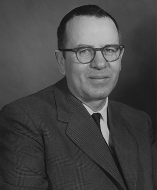 a person wearing glasses and a suit