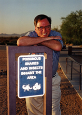 a person leaning on a sign