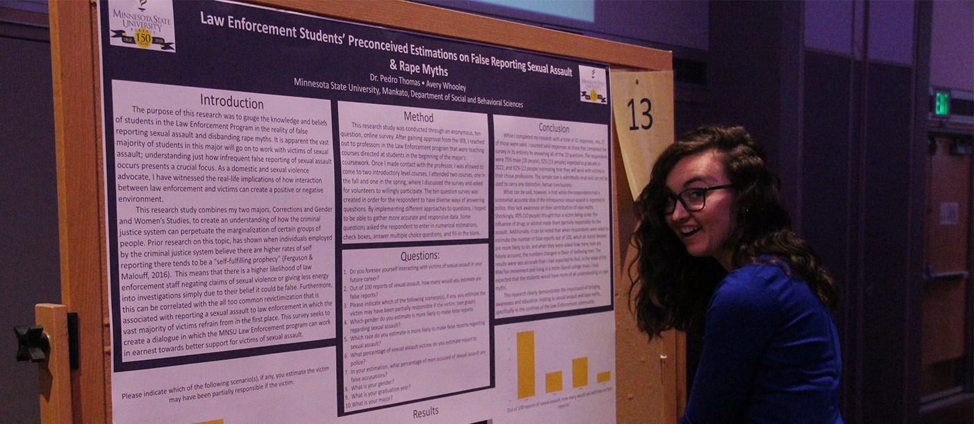Graduate student in front of her presentation