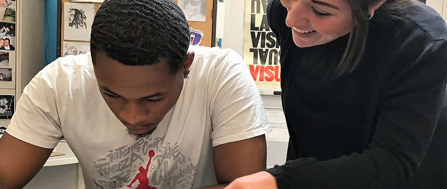 Art Education instructor assisting student in the classroom