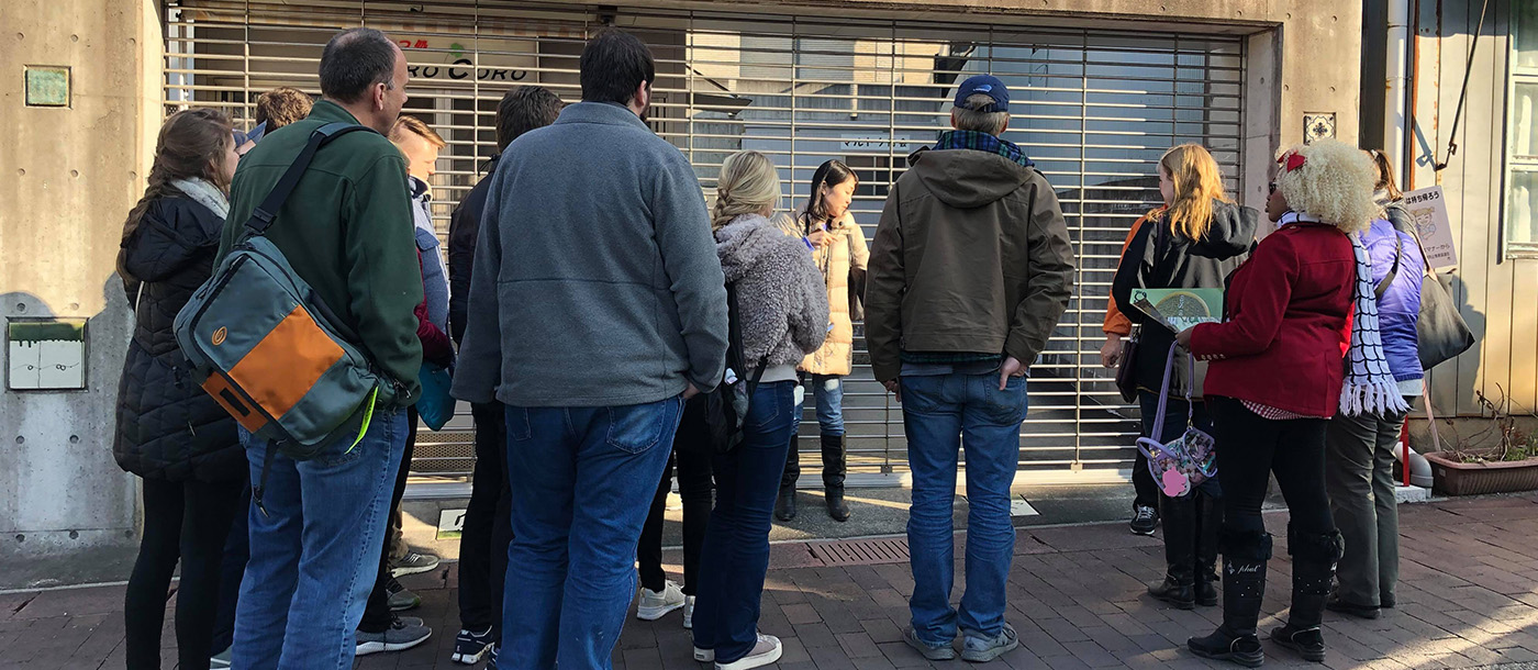 People listening to a female guide